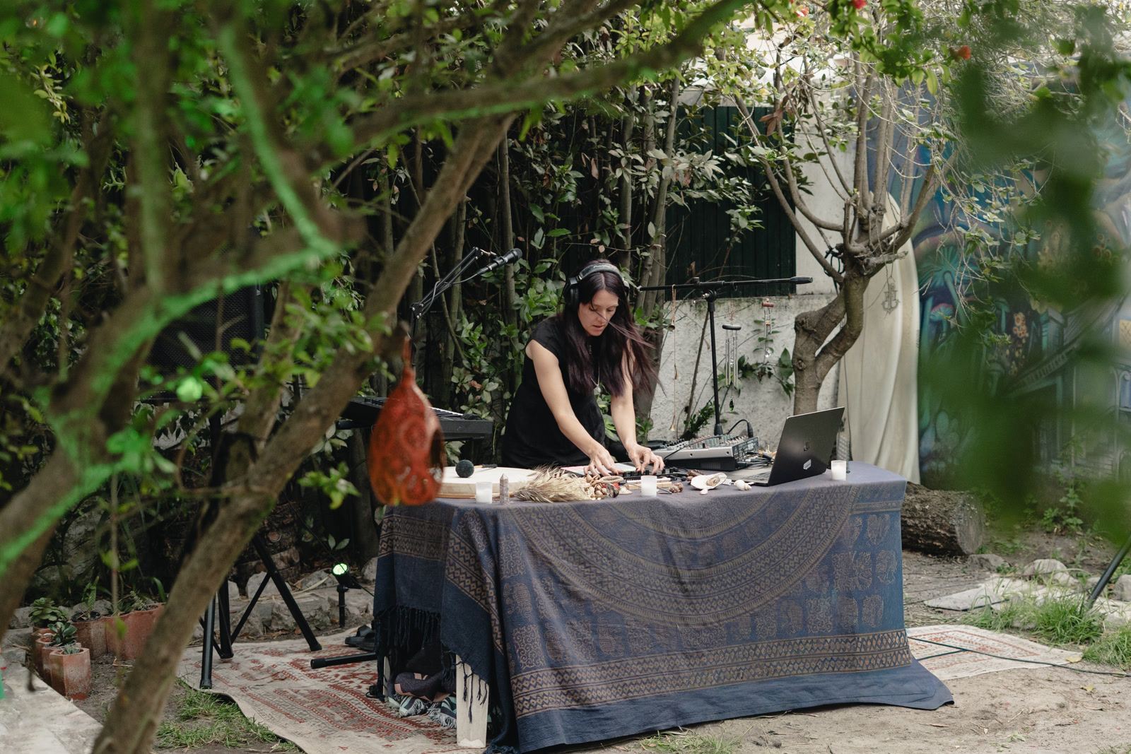 An outdoor live electronic set surrounded by trees